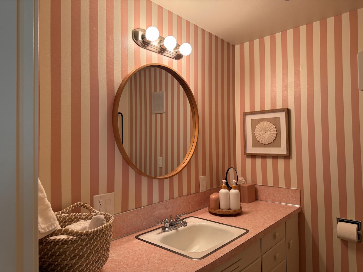The mirror and sink in the pink bathroom.